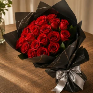 Red roses wrapped in black marbled paper with a silver ribbon