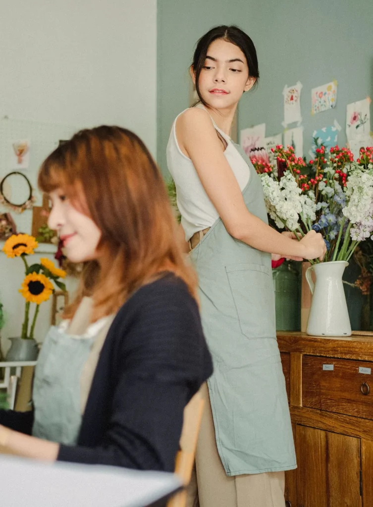 A florist arranging a bouquet at a workbench